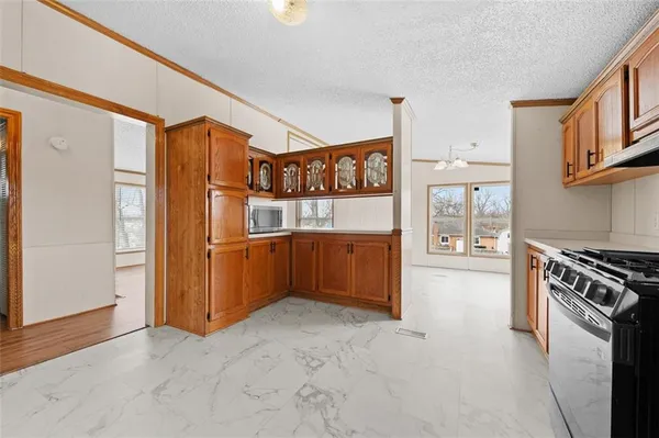 a kitchen with stainless steel appliances granite countertop a refrigerator and a stove