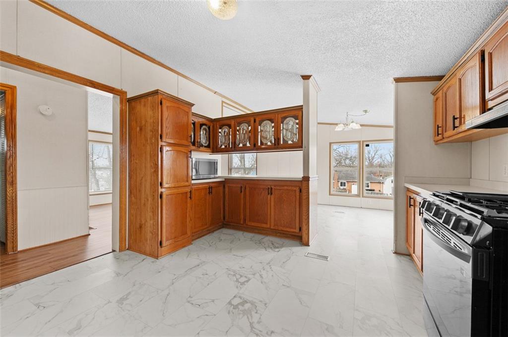 107 Indigo Road Mount Pleasant, PA 15666 - Photo 9 of 36 a kitchen with stainless steel appliances granite countertop a refrigerator and a stove