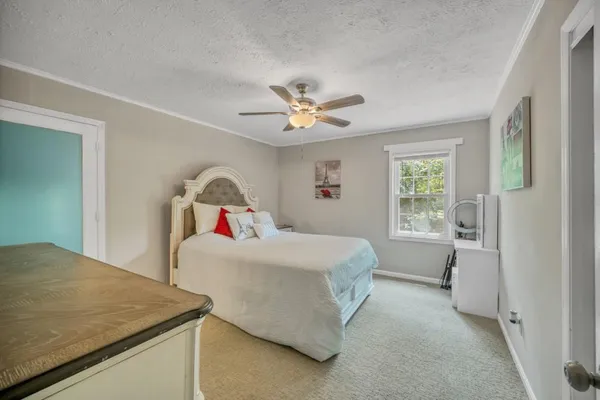 a bedroom with a bed and a chandelier