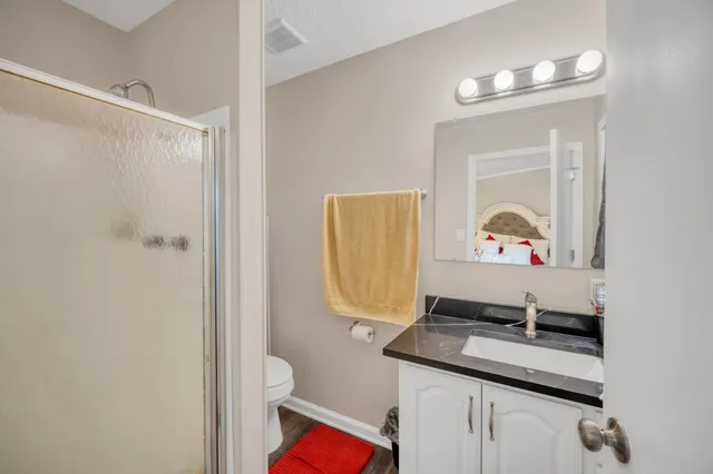 a bathroom with a sink a mirror and a toilet