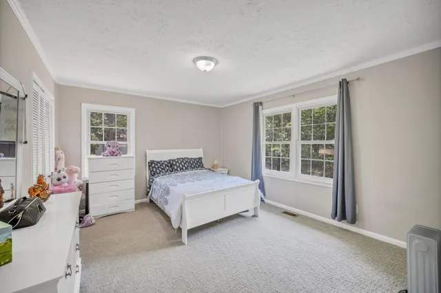 a bed room with a bed and a window