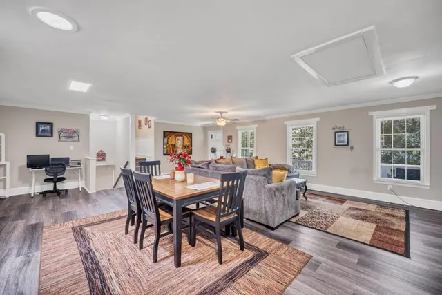 a view of a dining room with furniture window and wooden floor
