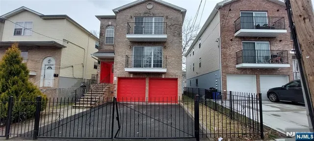 a view of a brick house with many windows