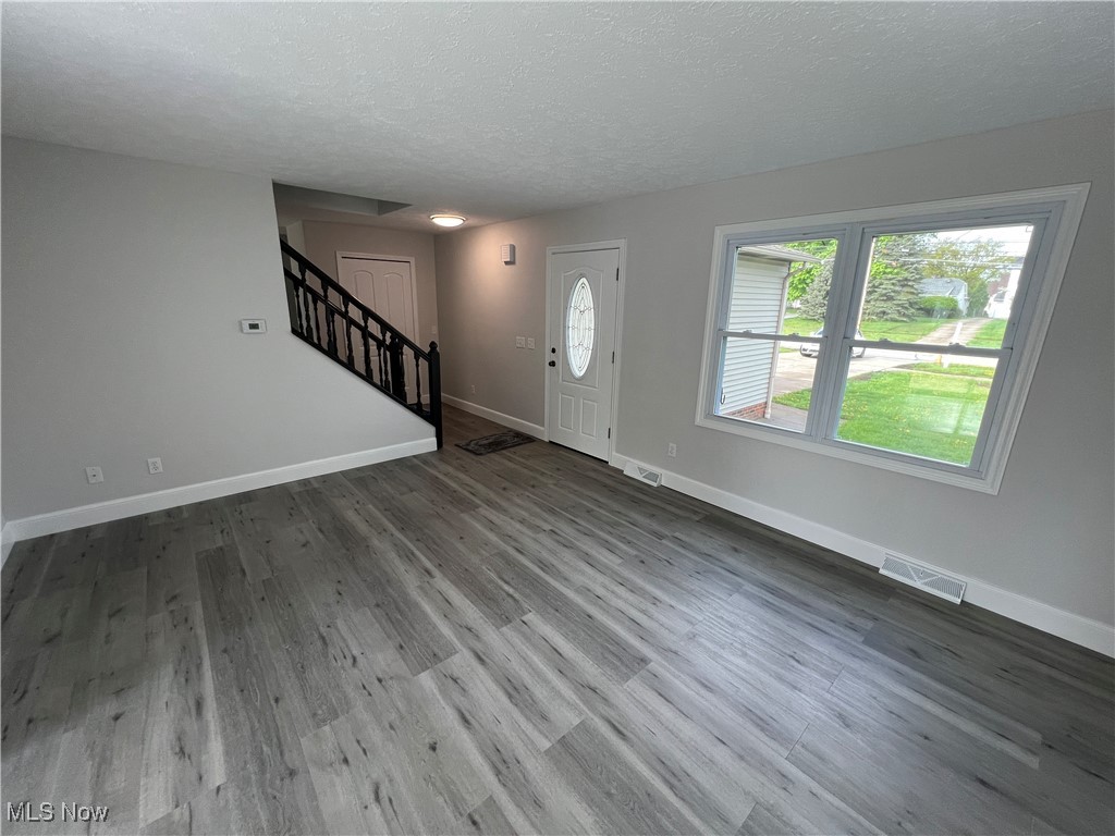 1279 Lander Road Cleveland, OH 44124 - Photo 21 of 37 Entrance foyer with baseboards, stairway, visible vents, and wood finished floors