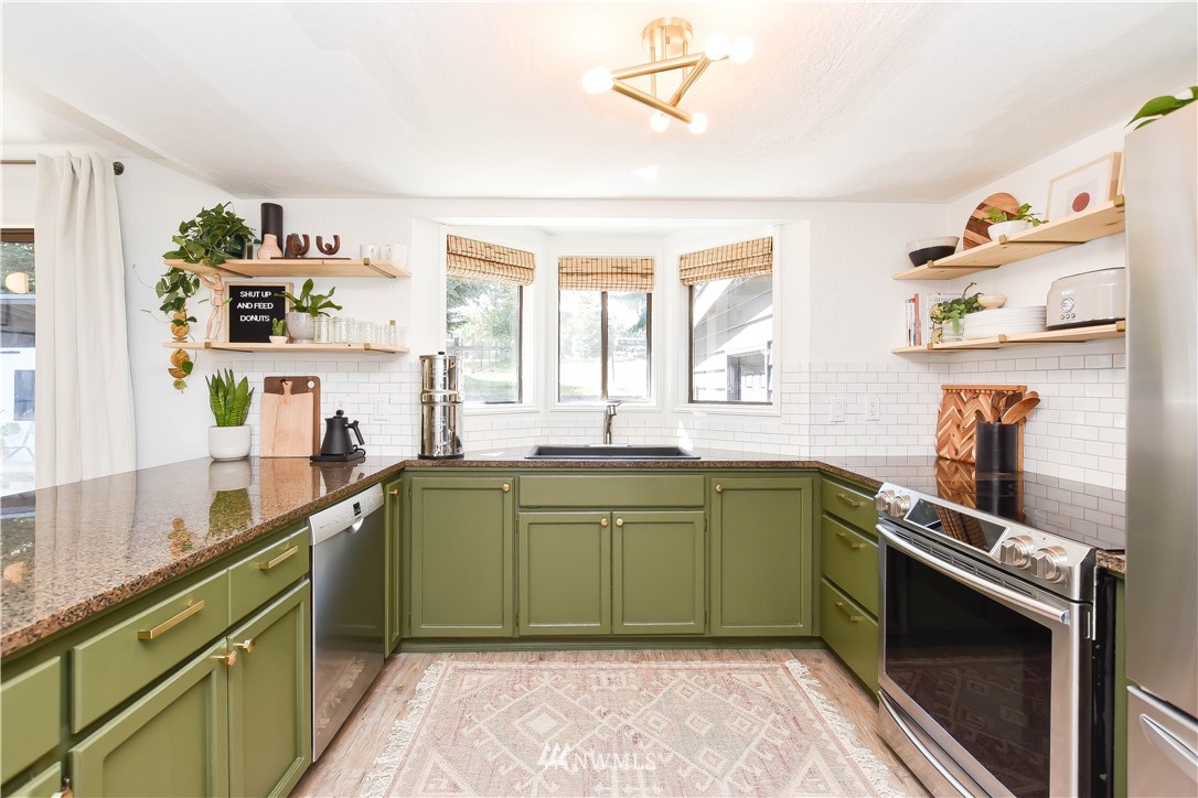 14516 Connelly Road Snohomish, WA 98296 - Photo 12 of 40 a kitchen with a sink a stove and cabinets