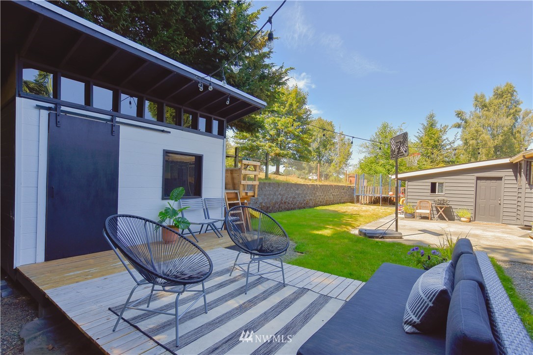 14516 Connelly Road Snohomish, WA 98296 - Photo 36 of 40 a patio with a table and chairs and potted plants