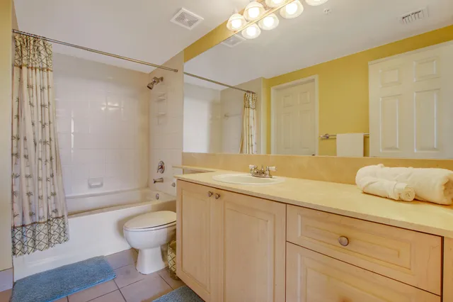 a spacious bathroom with a granite countertop sink toilet and shower
