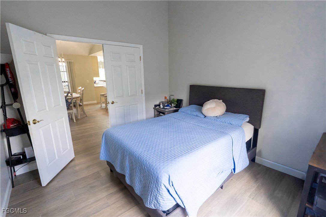 14557 Eagle Ridge Drive Fort Myers, FL 33912 - Photo 13 of 20 a bedroom with a bed and wooden floor