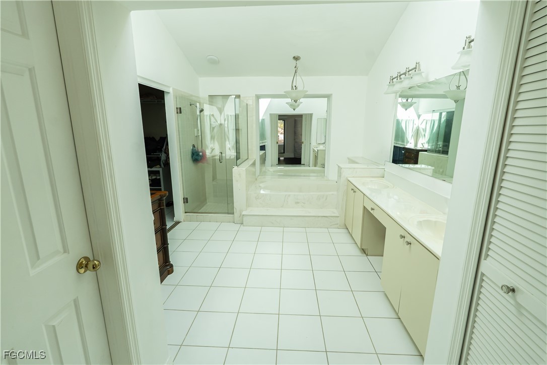 14557 Eagle Ridge Drive Fort Myers, FL 33912 - Photo 19 of 20 a bathroom with a shower and a mirror