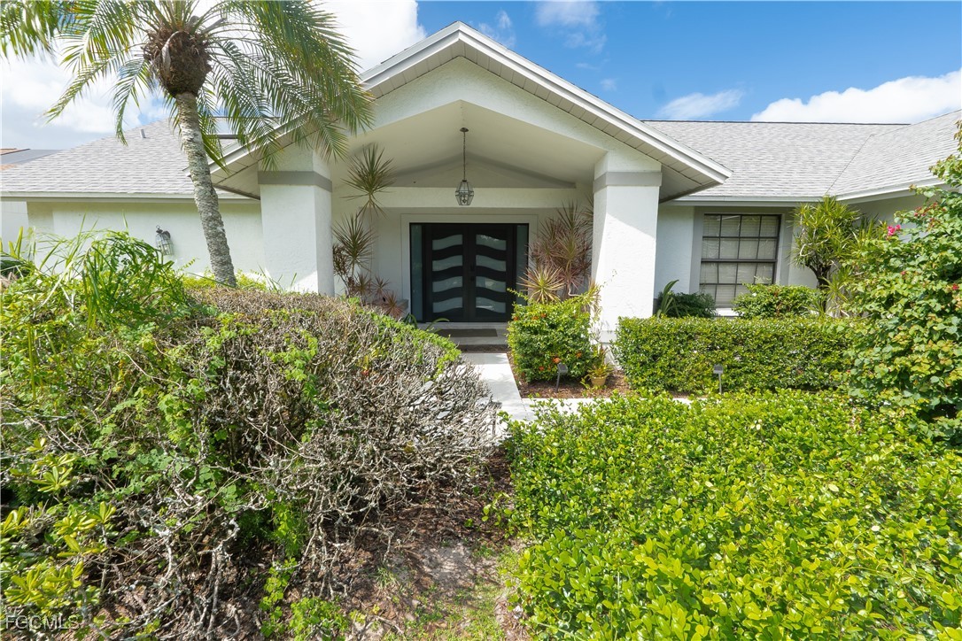 14557 Eagle Ridge Drive Fort Myers, FL 33912 - Photo 3 of 20 front view of a house with a yard