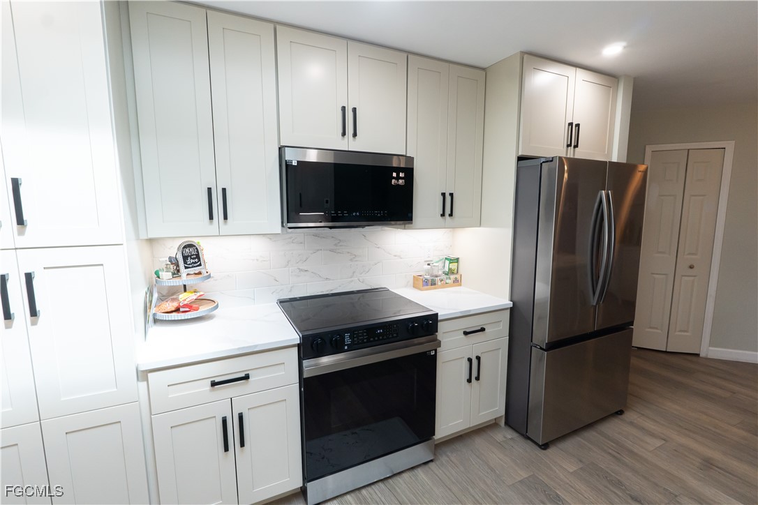 14557 Eagle Ridge Drive Fort Myers, FL 33912 - Photo 8 of 20 a kitchen with stainless steel appliances a refrigerator stove and sink