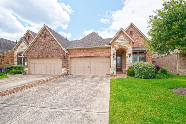 front view of a house with a yard and an trees