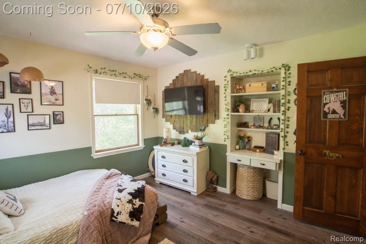 5278 Skelton Road Columbiaville, MI 48421 - Photo 53 of 64 Spacious room featuring wood-finish flooring, a ceiling fan with integrated lighting, and a prominent window