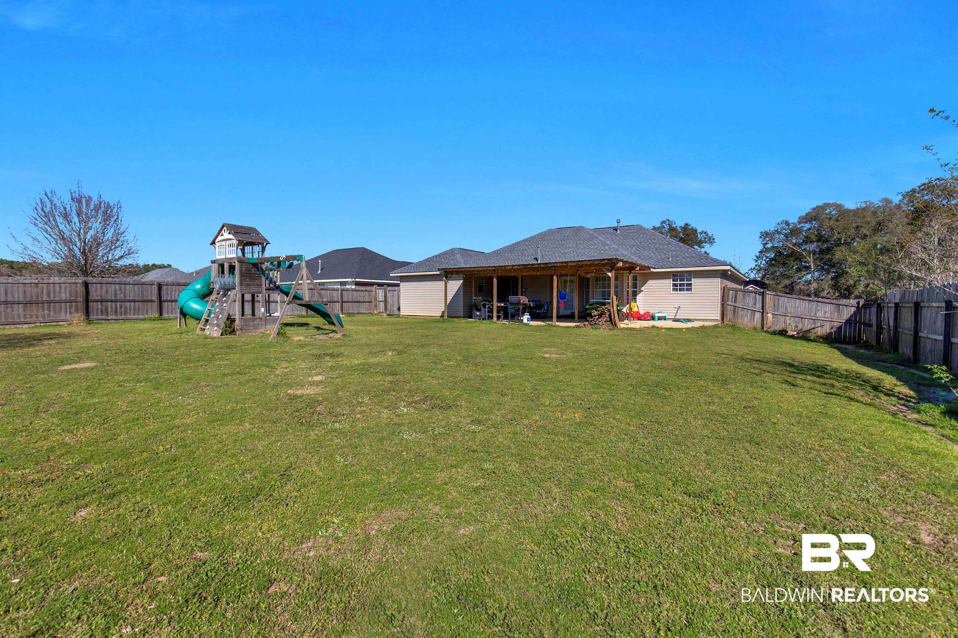 4950 Clealand Court Mobile, AL 36695 - Photo 18 of 20 View of yard featuring a patio area, a playground, and a fenced backyard