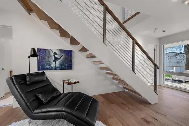 a living room with furniture and stairs