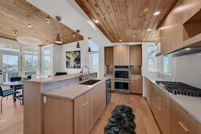 a kitchen with a sink a stove and cabinets