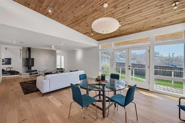 a living room with dining room and wooden floor
