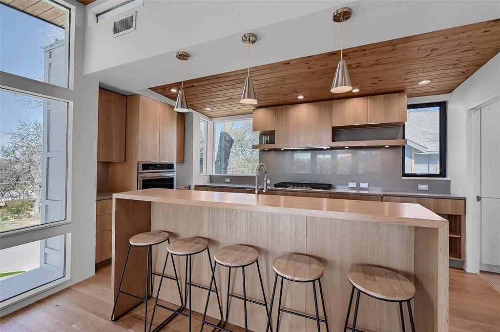 715 North Elm Street Sherman, TX 75090 - Photo 2 of 39 a kitchen with stainless steel appliances granite countertop a sink a stove and a refrigerator