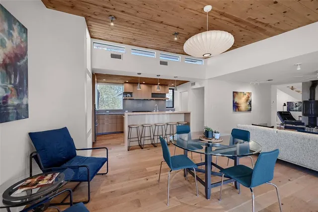a dining room with furniture and wooden floor