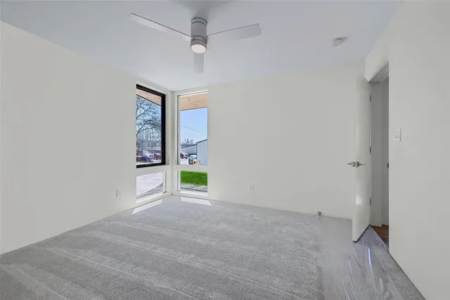 a view of a hallway with wooden floor and closet area