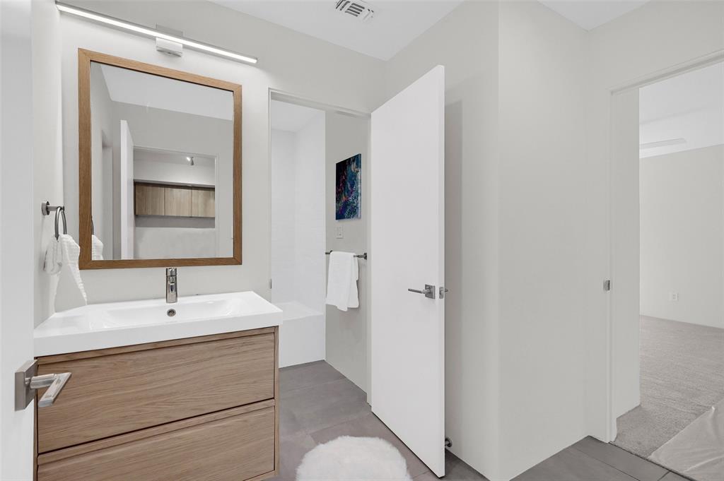 715 North Elm Street Sherman, TX 75090 - Photo 35 of 39 a bathroom with a sink and a mirror