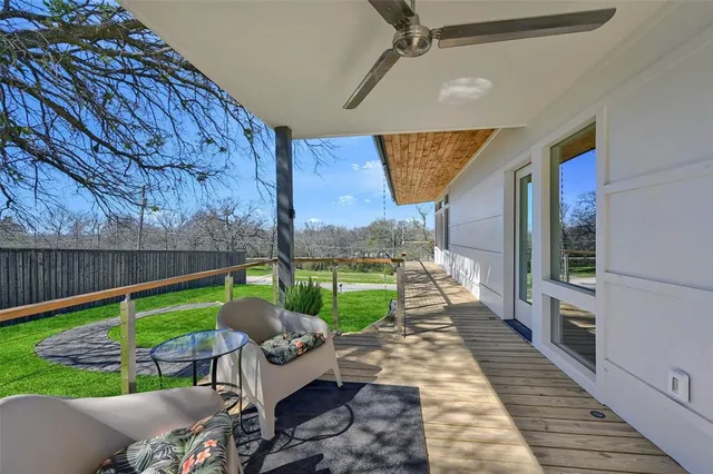 a view of a porch with furniture and a yard