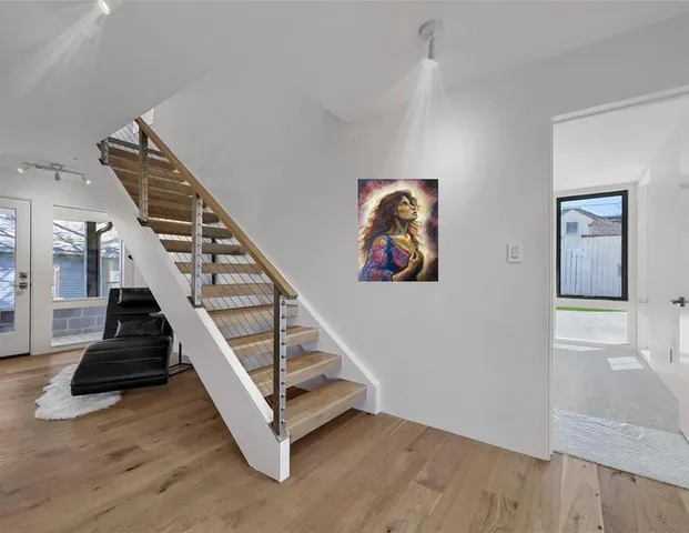 a view of entryway and hall with wooden floor