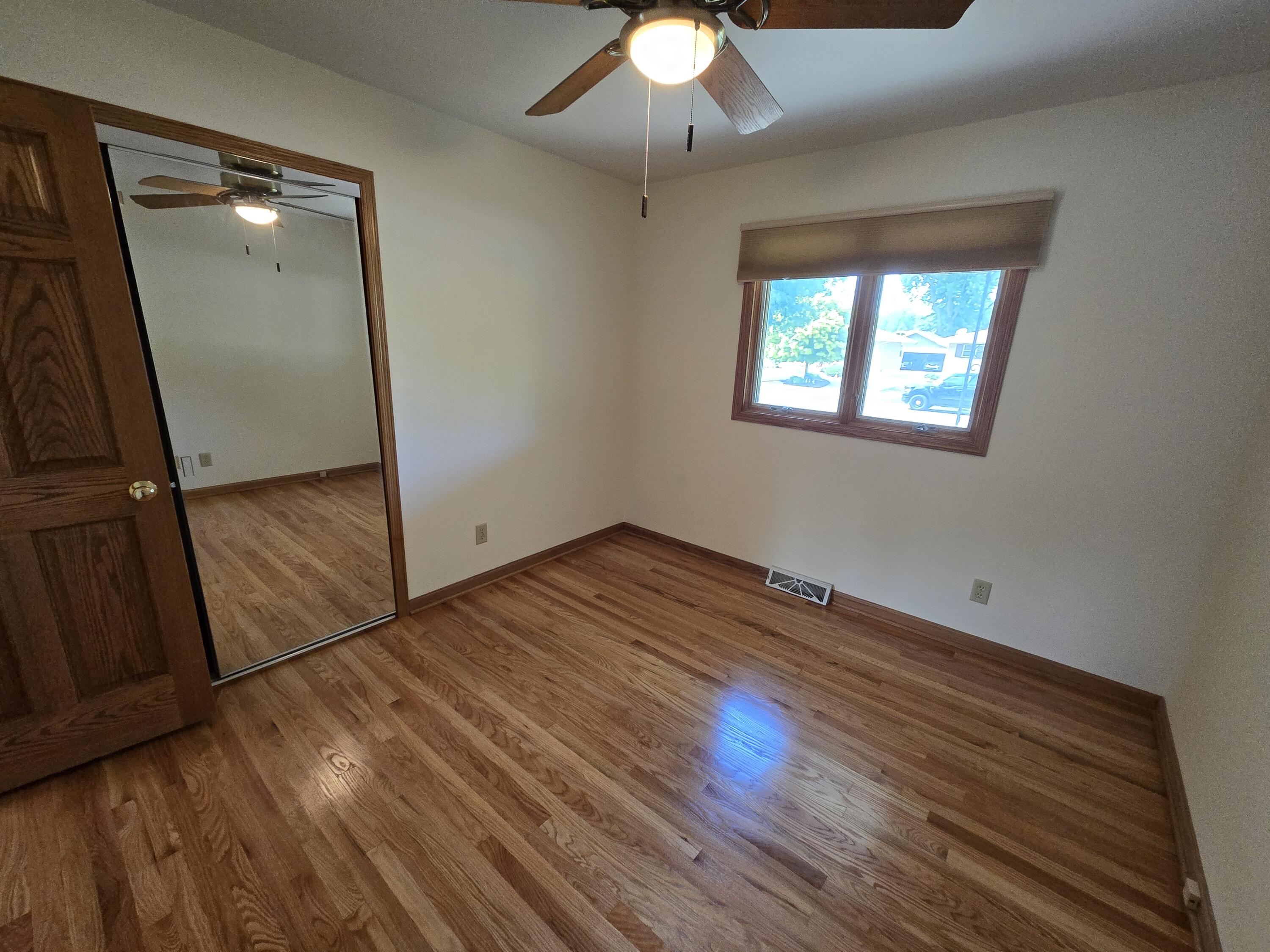 1828 Wren Drive Munster, IN 46321 - Photo 20 of 36 an empty room with wooden floor cabinet and windows