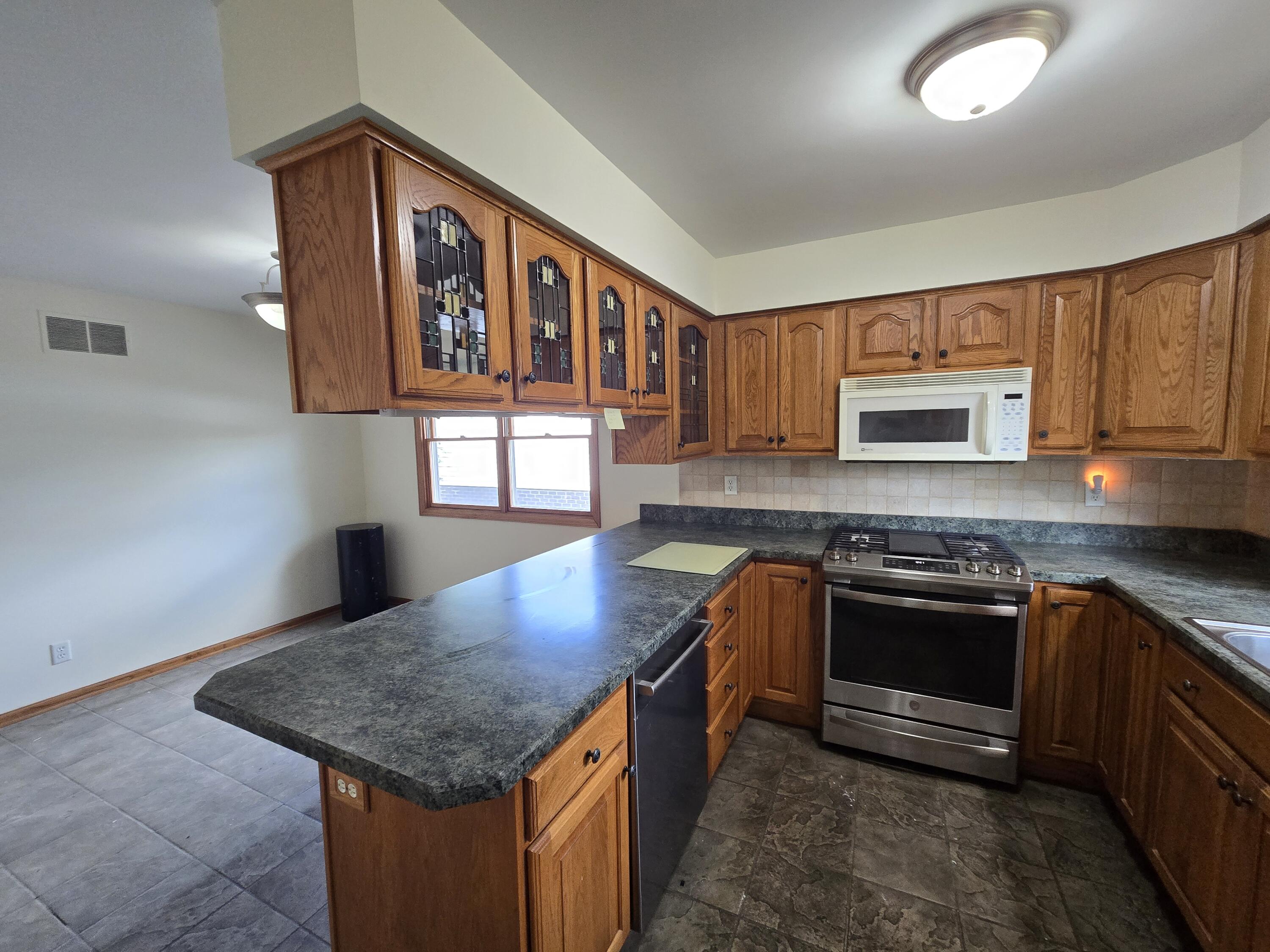 1828 Wren Drive Munster, IN 46321 - Photo 8 of 36 a kitchen with stainless steel appliances granite countertop a stove and a sink