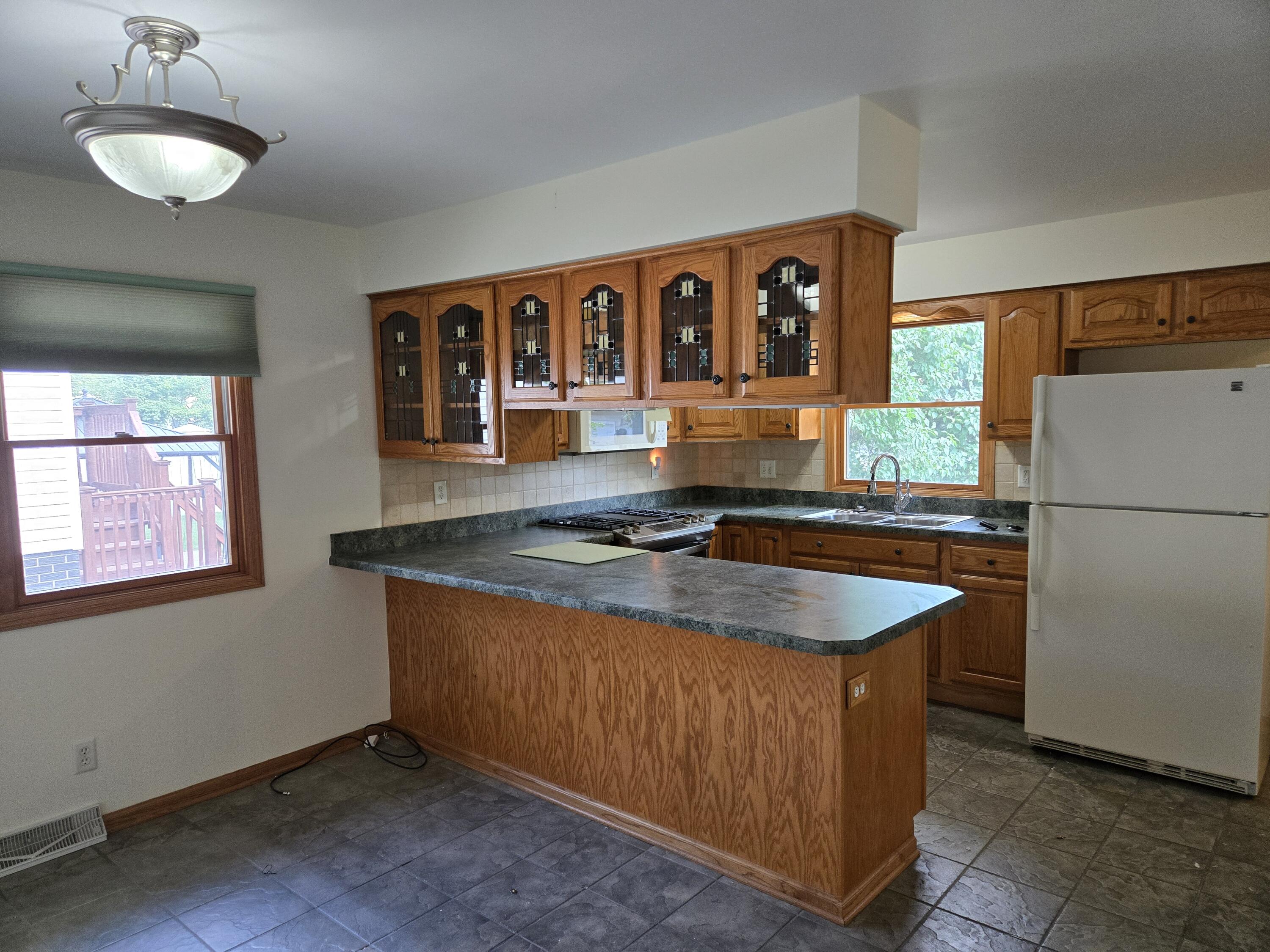 1828 Wren Drive Munster, IN 46321 - Photo 9 of 36 a kitchen with stainless steel appliances granite countertop a sink and a refrigerator