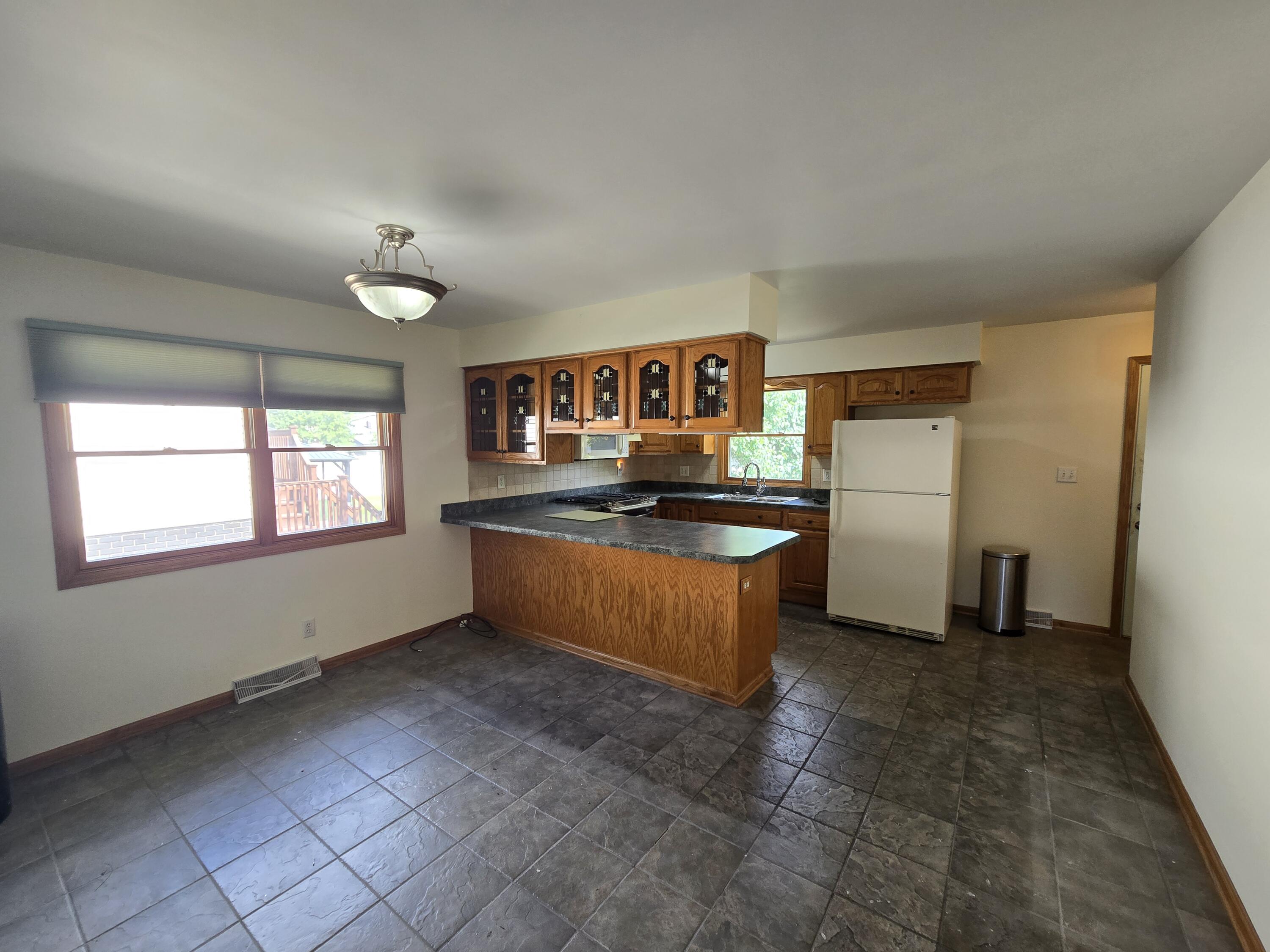 1828 Wren Drive Munster, IN 46321 - Photo 10 of 36 a kitchen with stainless steel appliances granite countertop a refrigerator and a sink