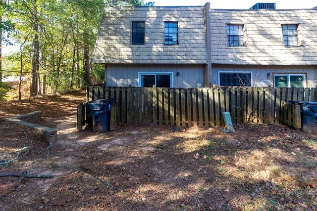 a view of a house with a yard and sitting area