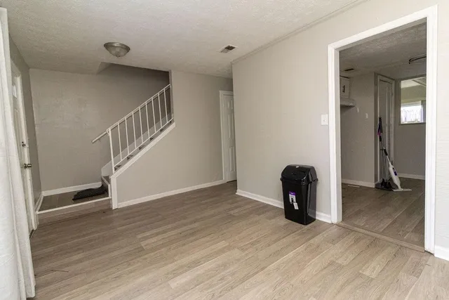 a view of an entryway with wooden floor