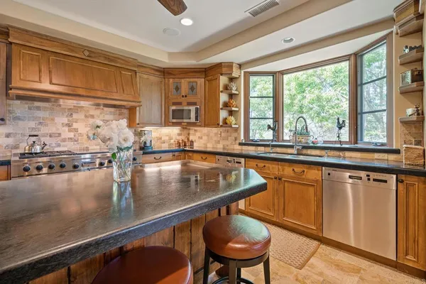 a kitchen with a sink and wooden cabinets