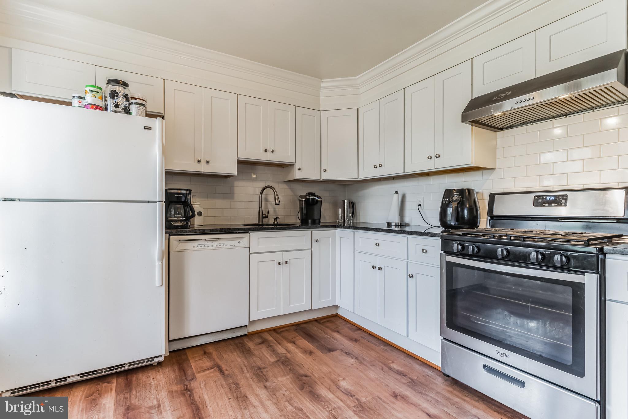 4926 Carriagepark Road Fairfax, VA 22032 - Photo 12 of 34 a kitchen with cabinets appliances and wooden floor