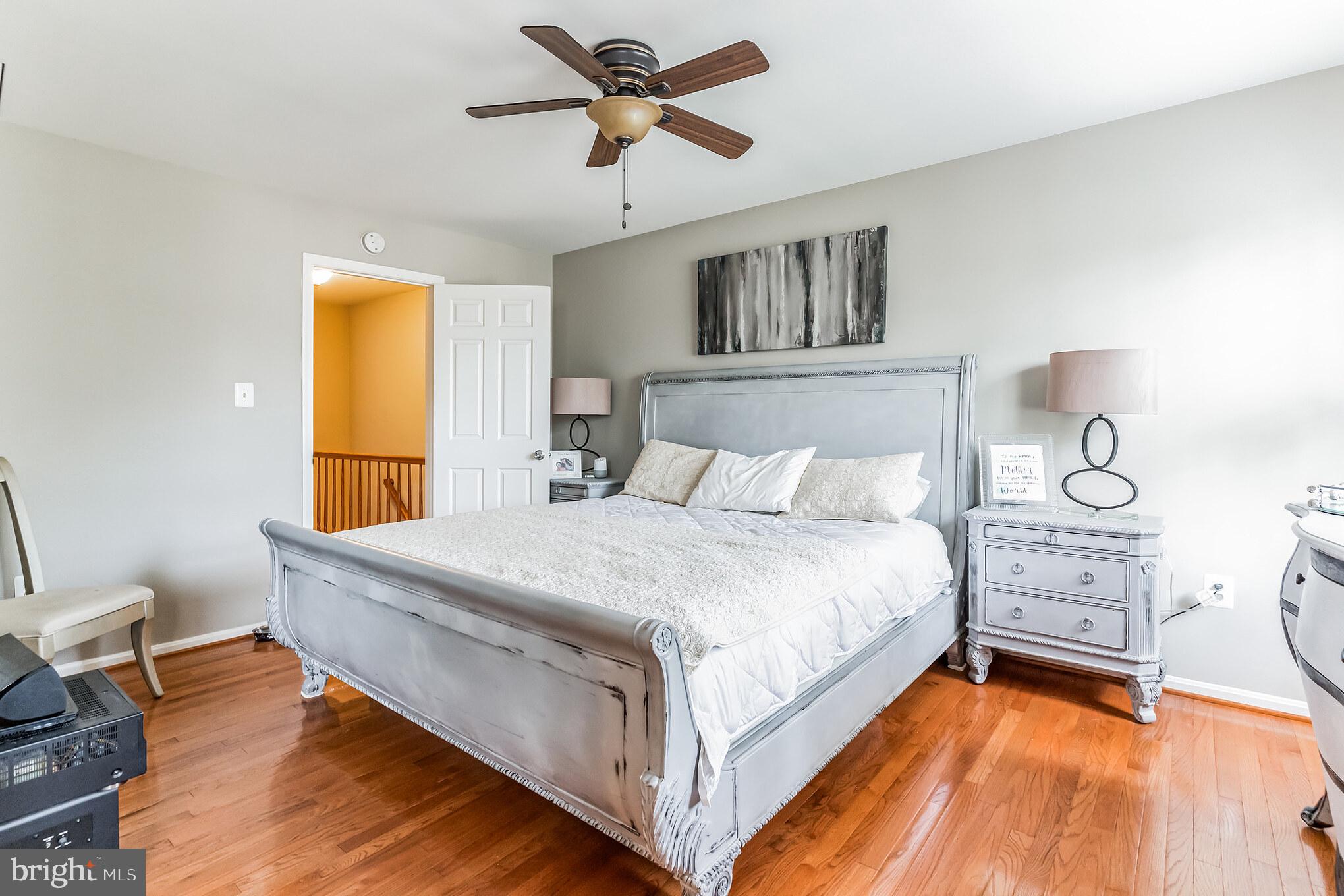 4926 Carriagepark Road Fairfax, VA 22032 - Photo 18 of 34 a bed room with a bed and a chandelier