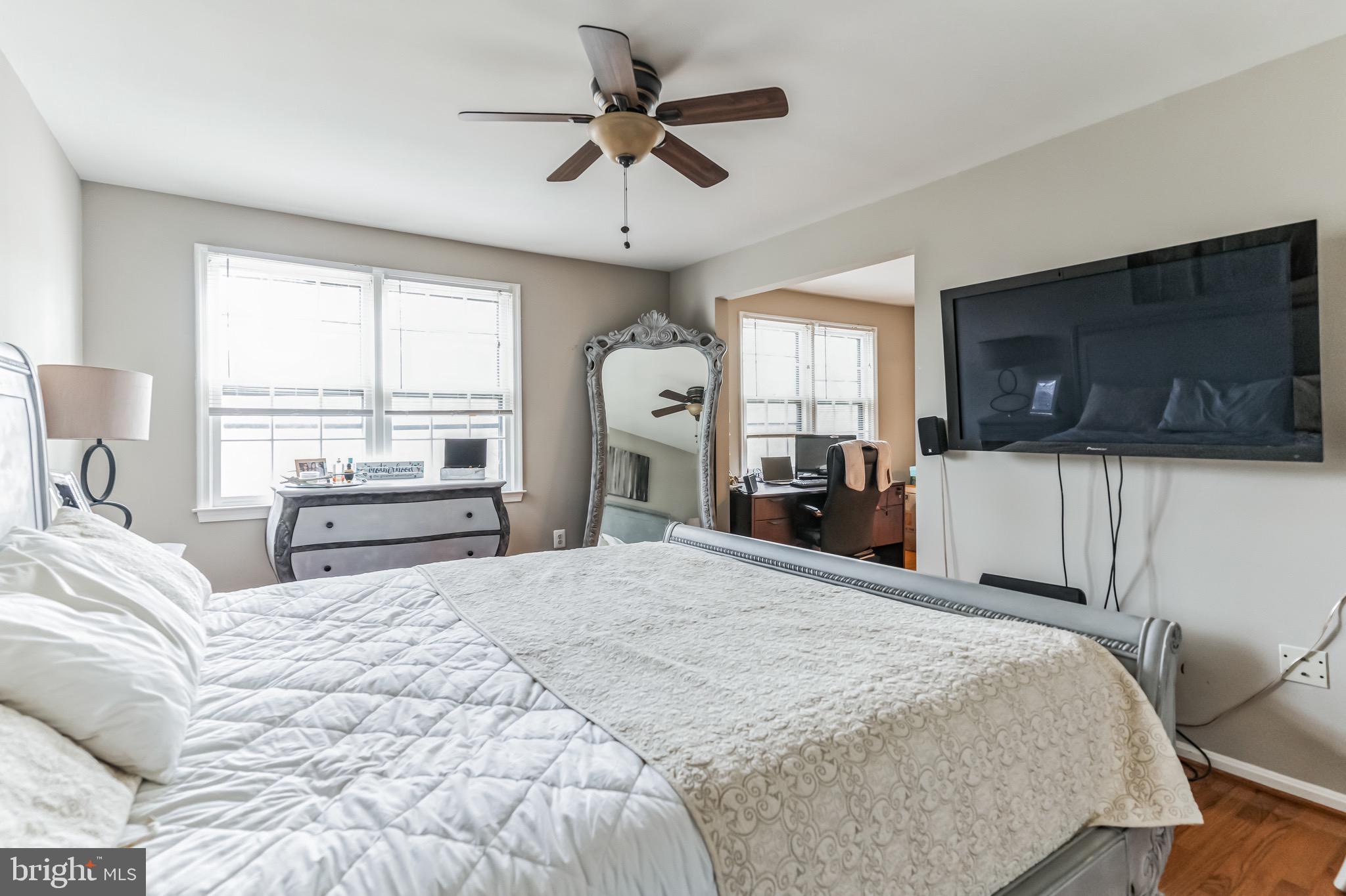 4926 Carriagepark Road Fairfax, VA 22032 - Photo 19 of 34 a bedroom with a bed a window and a flat screen tv