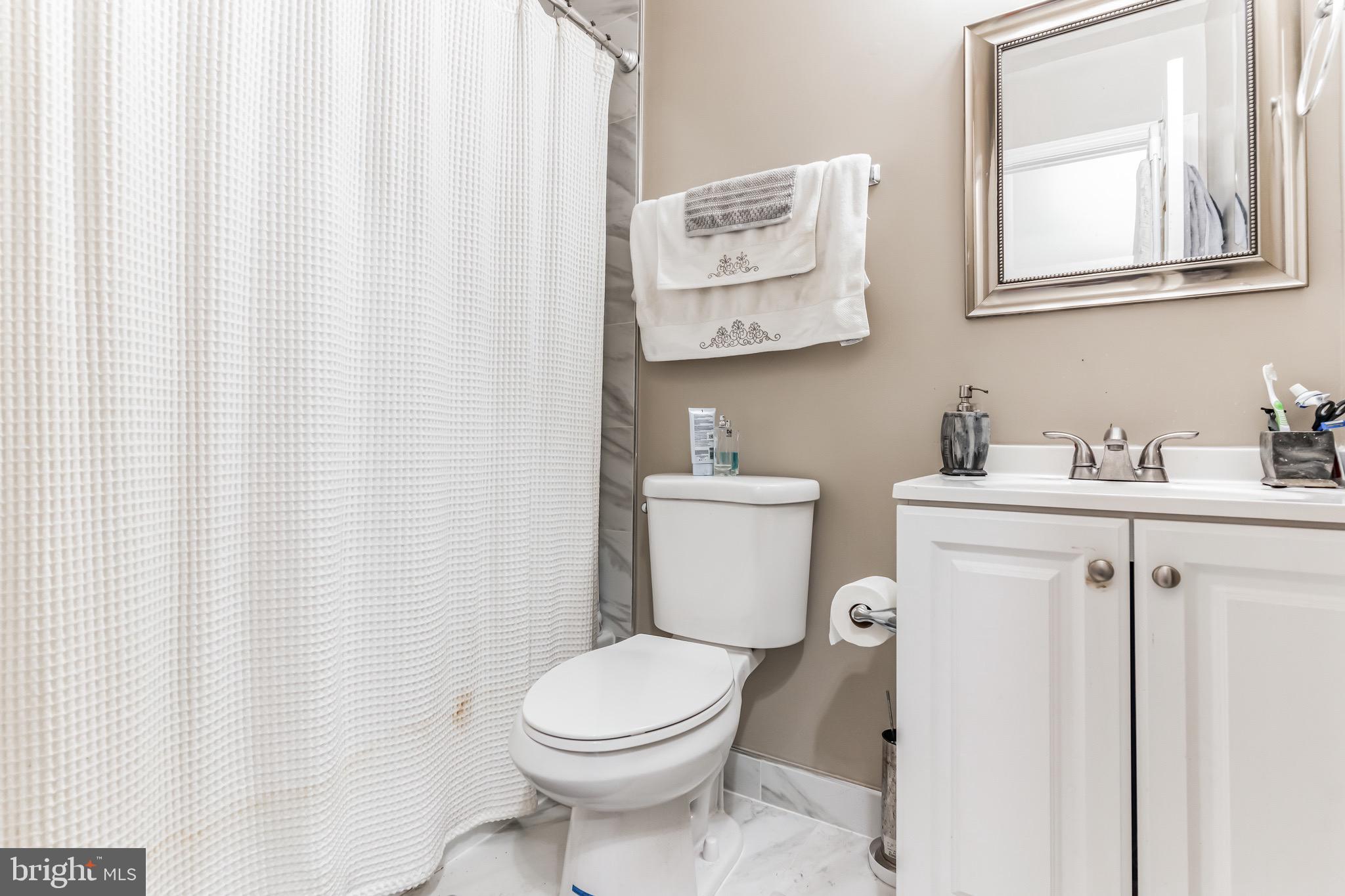 4926 Carriagepark Road Fairfax, VA 22032 - Photo 25 of 34 a bathroom with a toilet sink and vanity