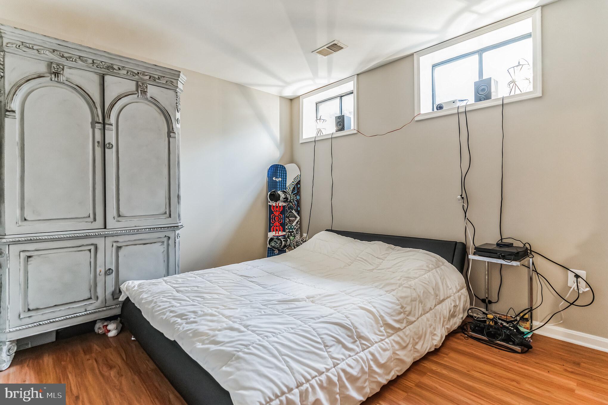 4926 Carriagepark Road Fairfax, VA 22032 - Photo 31 of 34 a bedroom with a bed and wooden floor