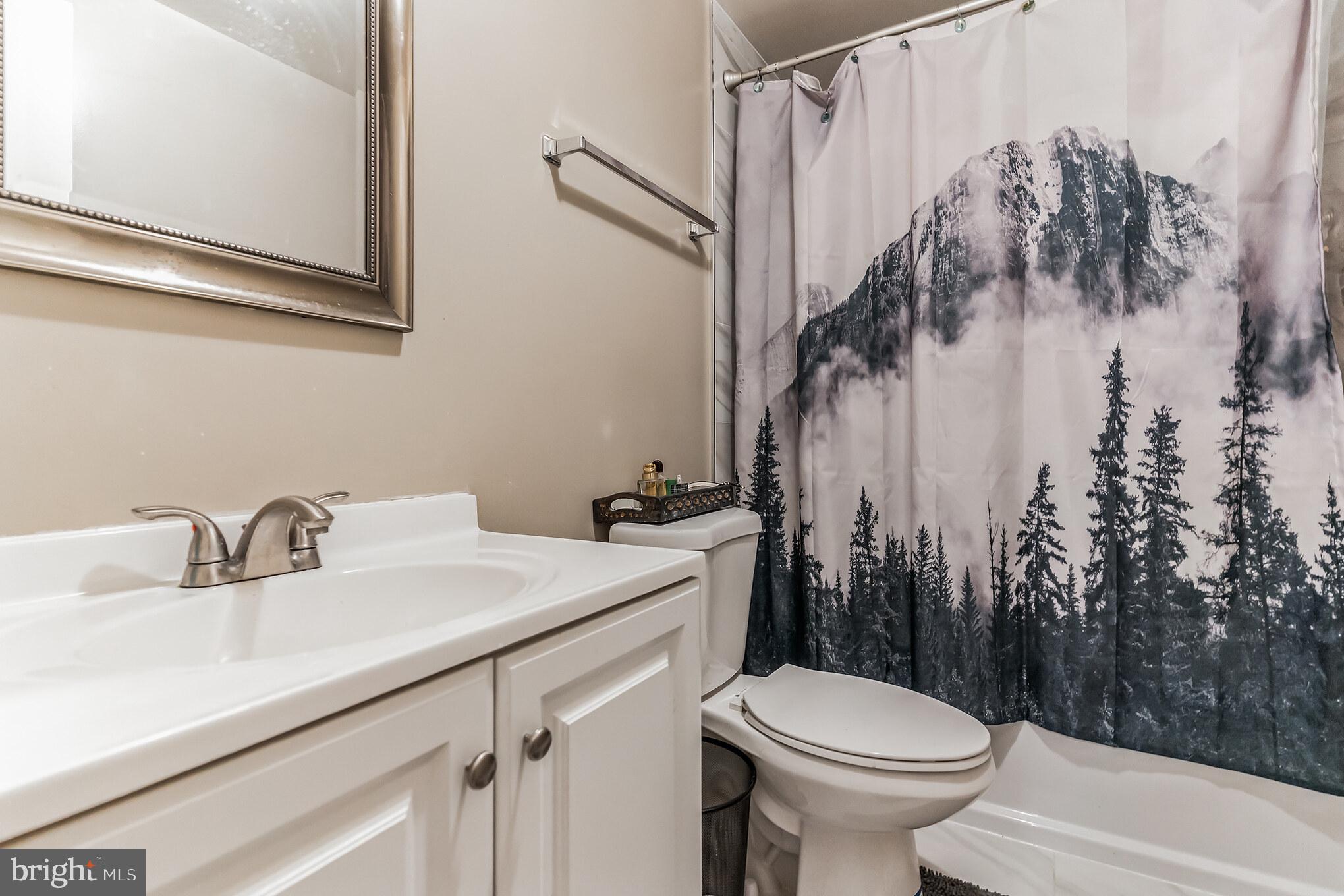 4926 Carriagepark Road Fairfax, VA 22032 - Photo 32 of 34 a bathroom with a sink toilet and shower