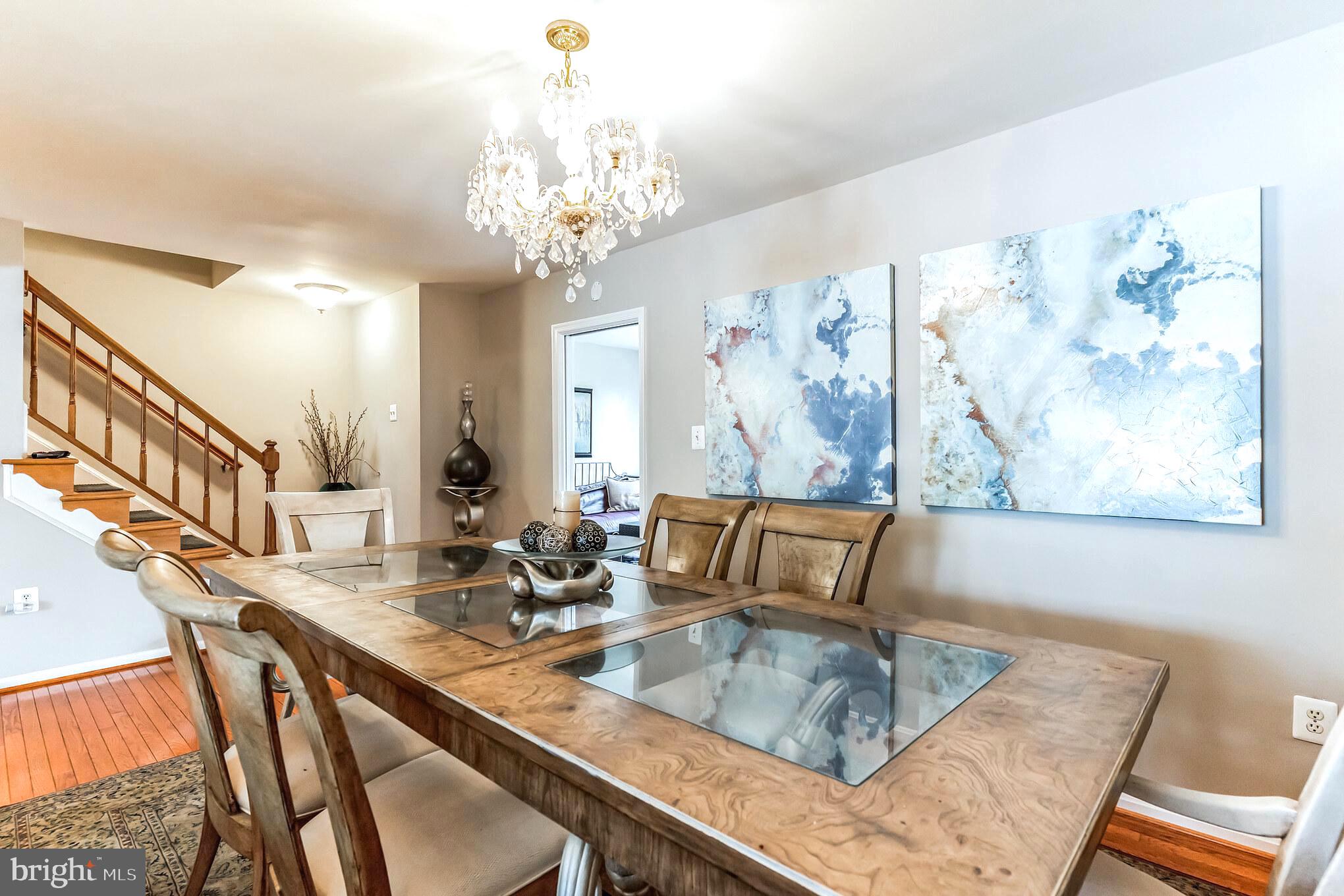 4926 Carriagepark Road Fairfax, VA 22032 - Photo 6 of 34 a view of a dining room with furniture a chandelier and wooden floor