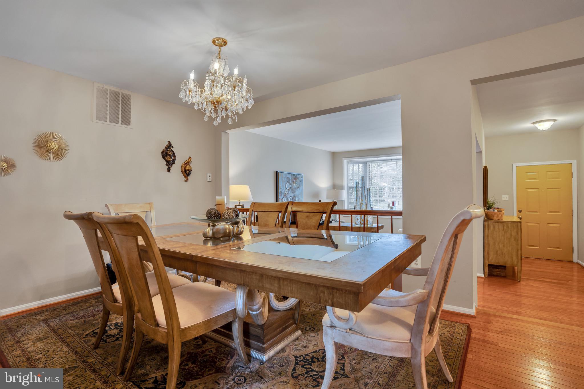 4926 Carriagepark Road Fairfax, VA 22032 - Photo 7 of 34 a view of a dining room with furniture and wooden floor
