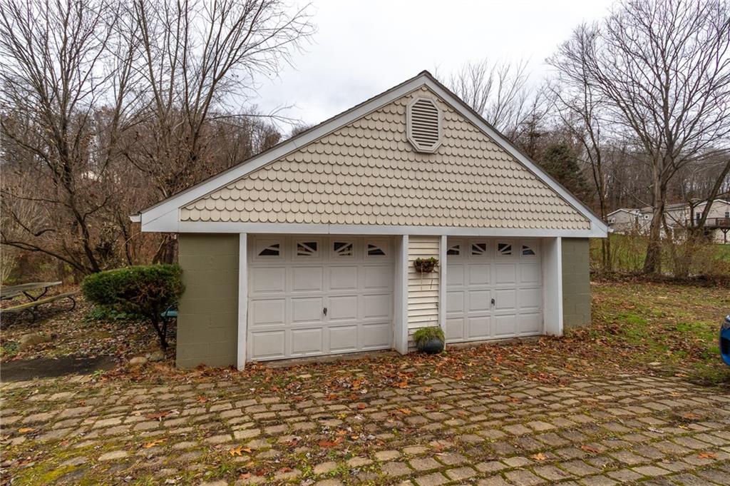 293 Upper Service Road Hookstown, PA 15050 - Photo 3 of 20 2 car detached garage, brick drive. Vinyl fish scale trim.