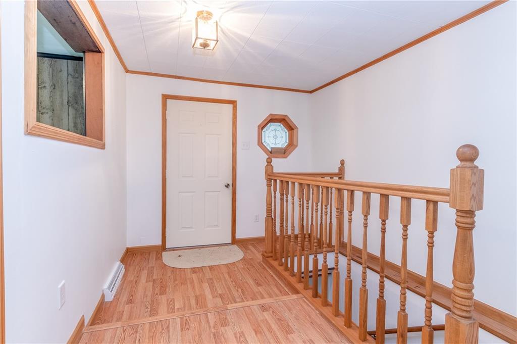 293 Upper Service Road Hookstown, PA 15050 - Photo 5 of 20 Entry from sunroom to home. Laminate flooring, staircase to basement.