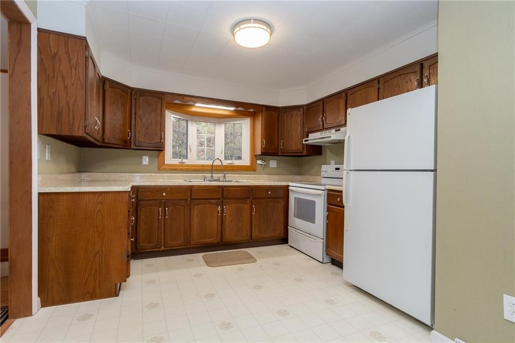 293 Upper Service Road Hookstown, PA 15050 - Photo 8 of 20 Kitchen with lots of cabinets and work area. Electric stove, large window, light and bright vinyl flooring.