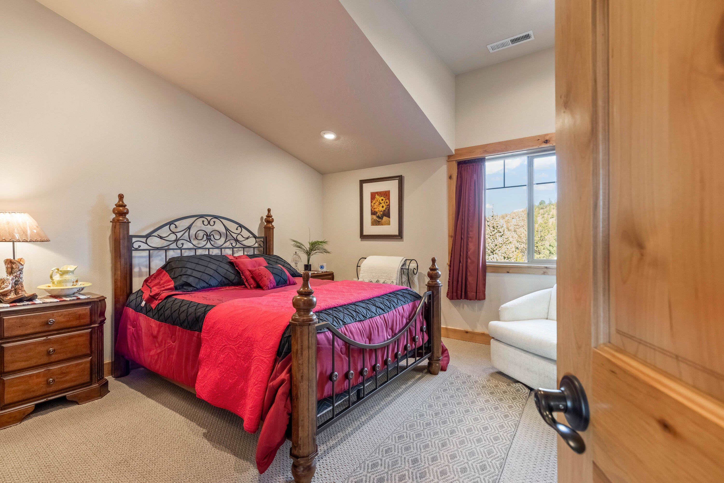 70030 Northwest Hunt Road Sisters, OR 97759 - Photo 24 of 55 a bedroom with a bed and a mirror
