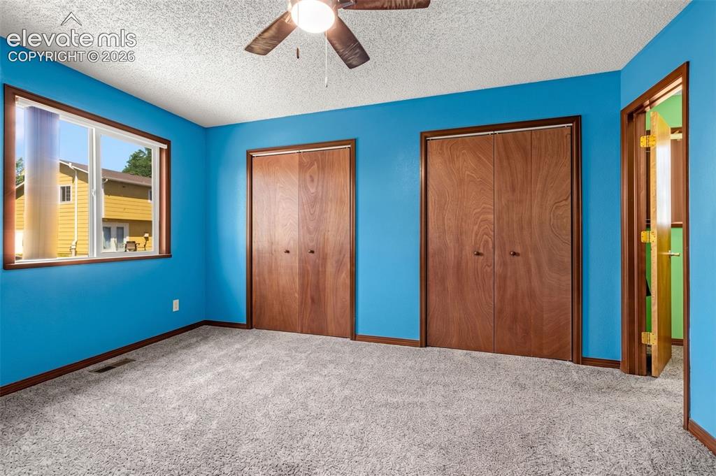 613 Wheat Field Road Fountain, CO 80817 - Photo 10 of 32 a view of an empty room with window and stairs