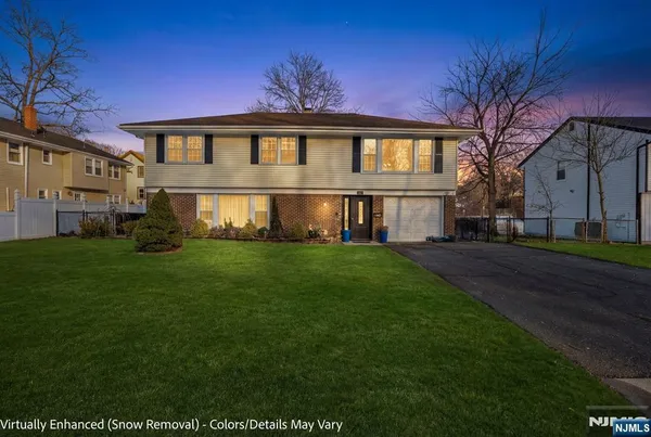 a front view of house with yard and green space