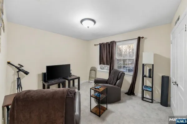 a bedroom with furniture and a flat screen tv