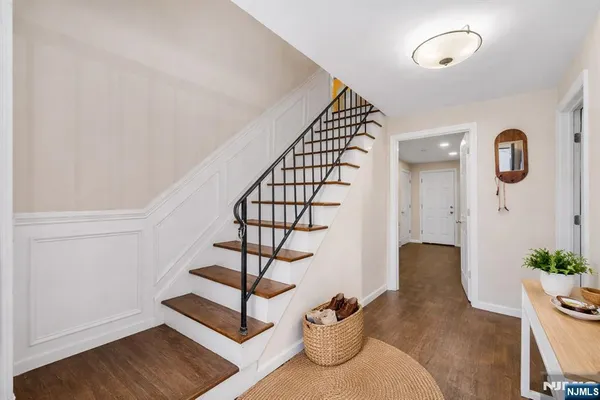 a view of entryway and hall with wooden floor